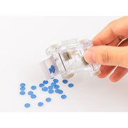 Hand emptying collected paper scraps from the clear Midori Mini Cleaner