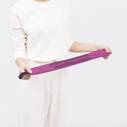 Hands pulling the Peony Petal Shupatto bag flat to fold it