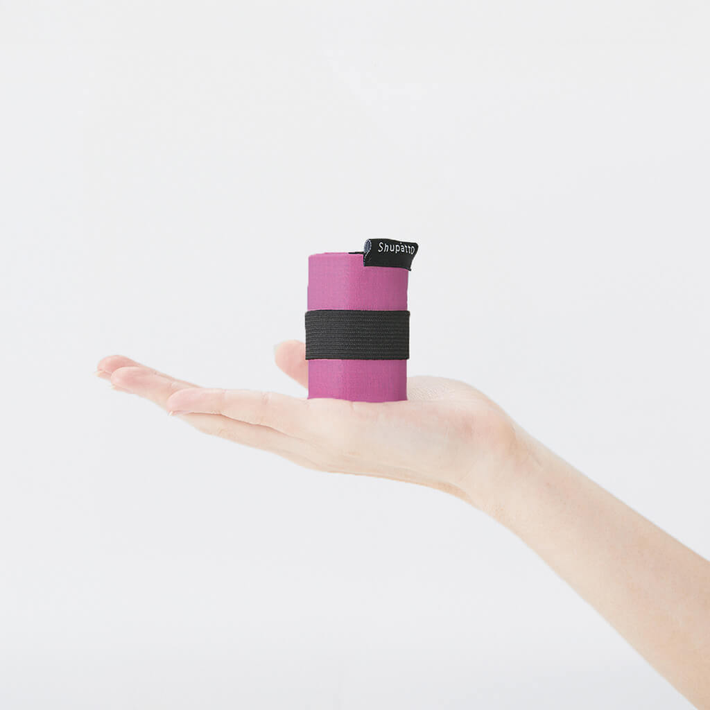 Folded Peony Petal Shupatto S bag resting in a hand